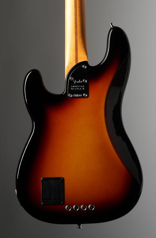 Electric bass guitar with sunburst finish on a gray background