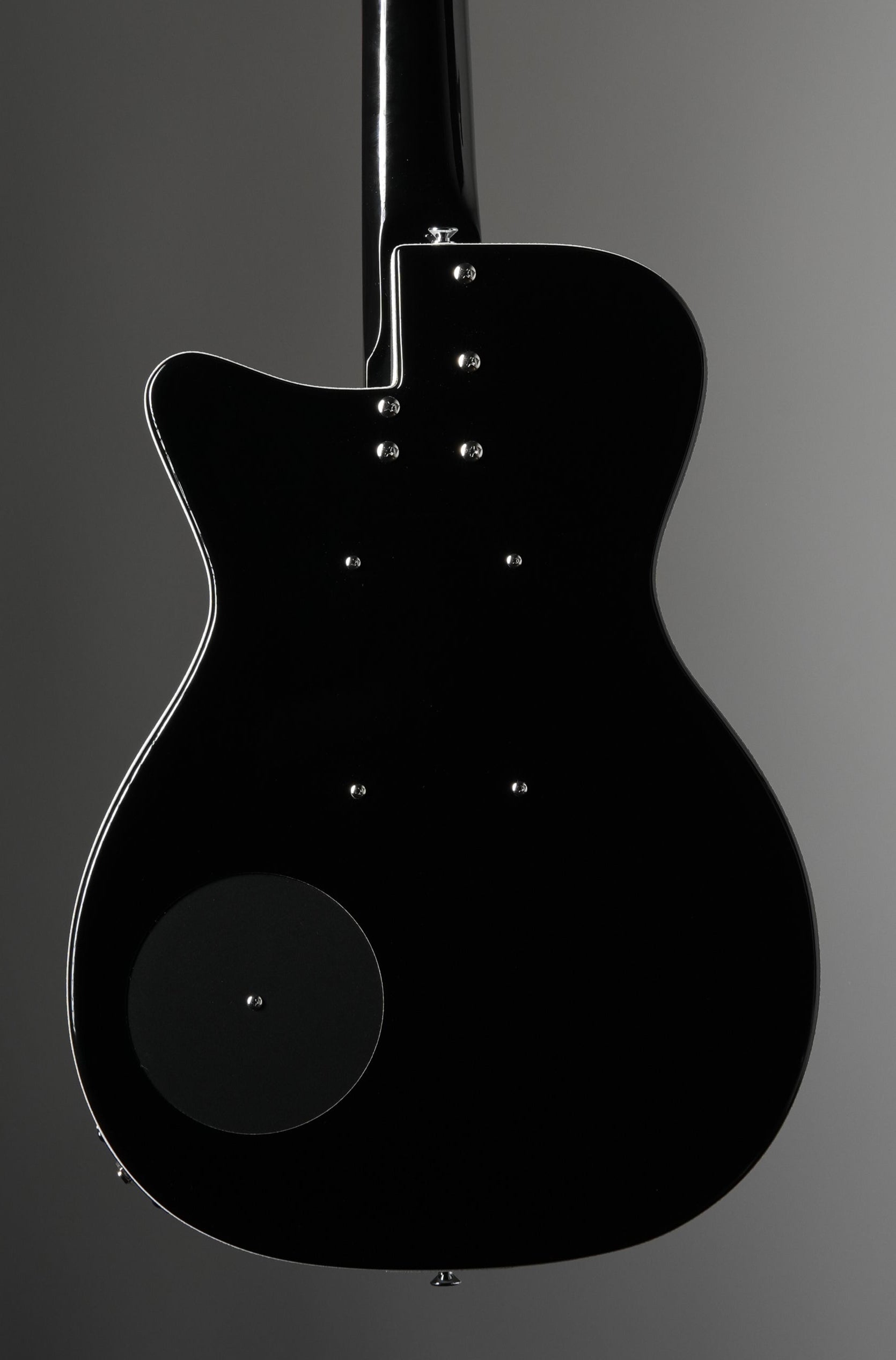 Black electric guitar on a gray background
