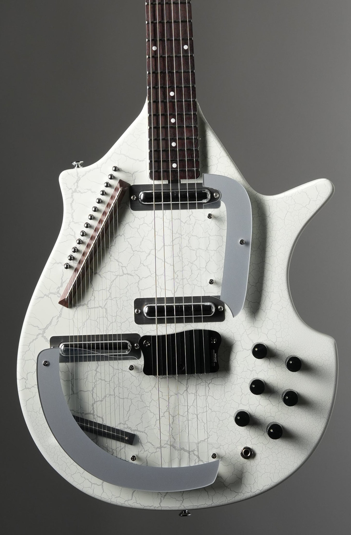 White electric guitar on a gray background
